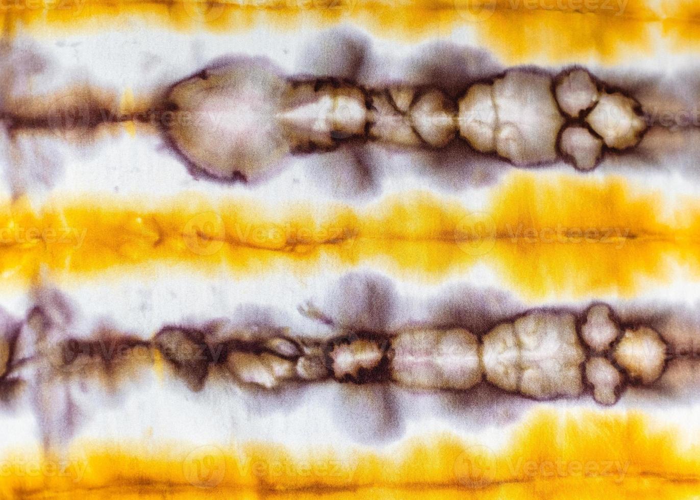 abstract spotted yellow and brown pattern in batik photo