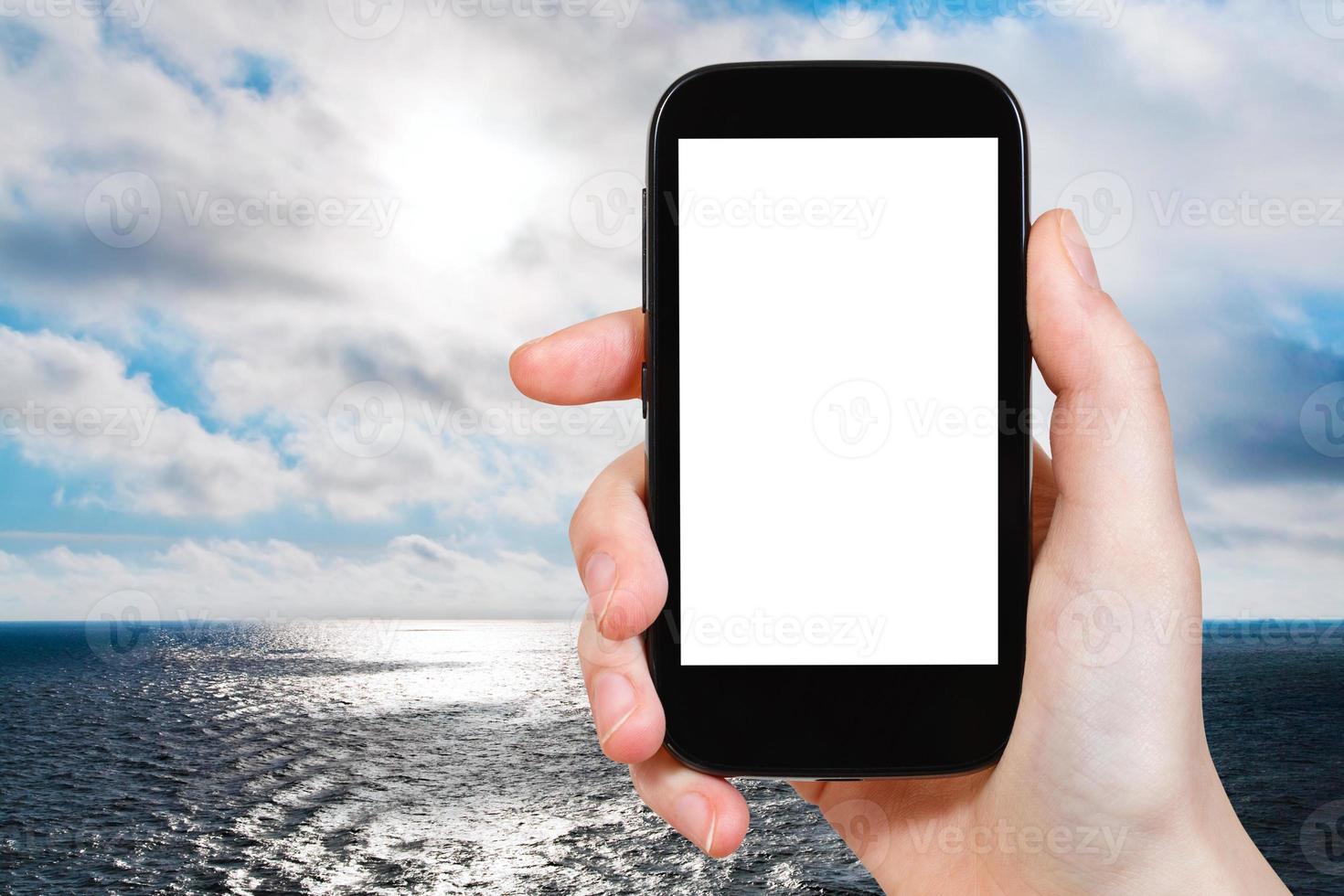 tourist photographs North Sea in evening photo