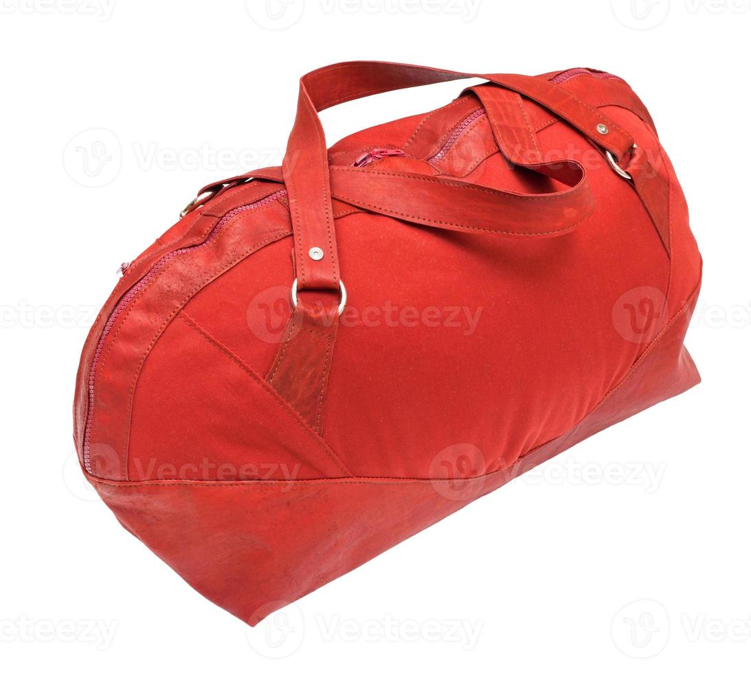 side view of red travelling bag isolated photo