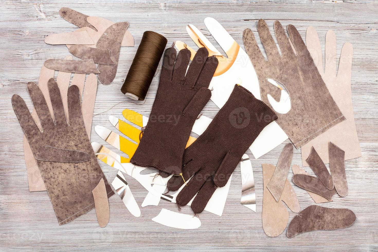various objects for gloves production on table photo
