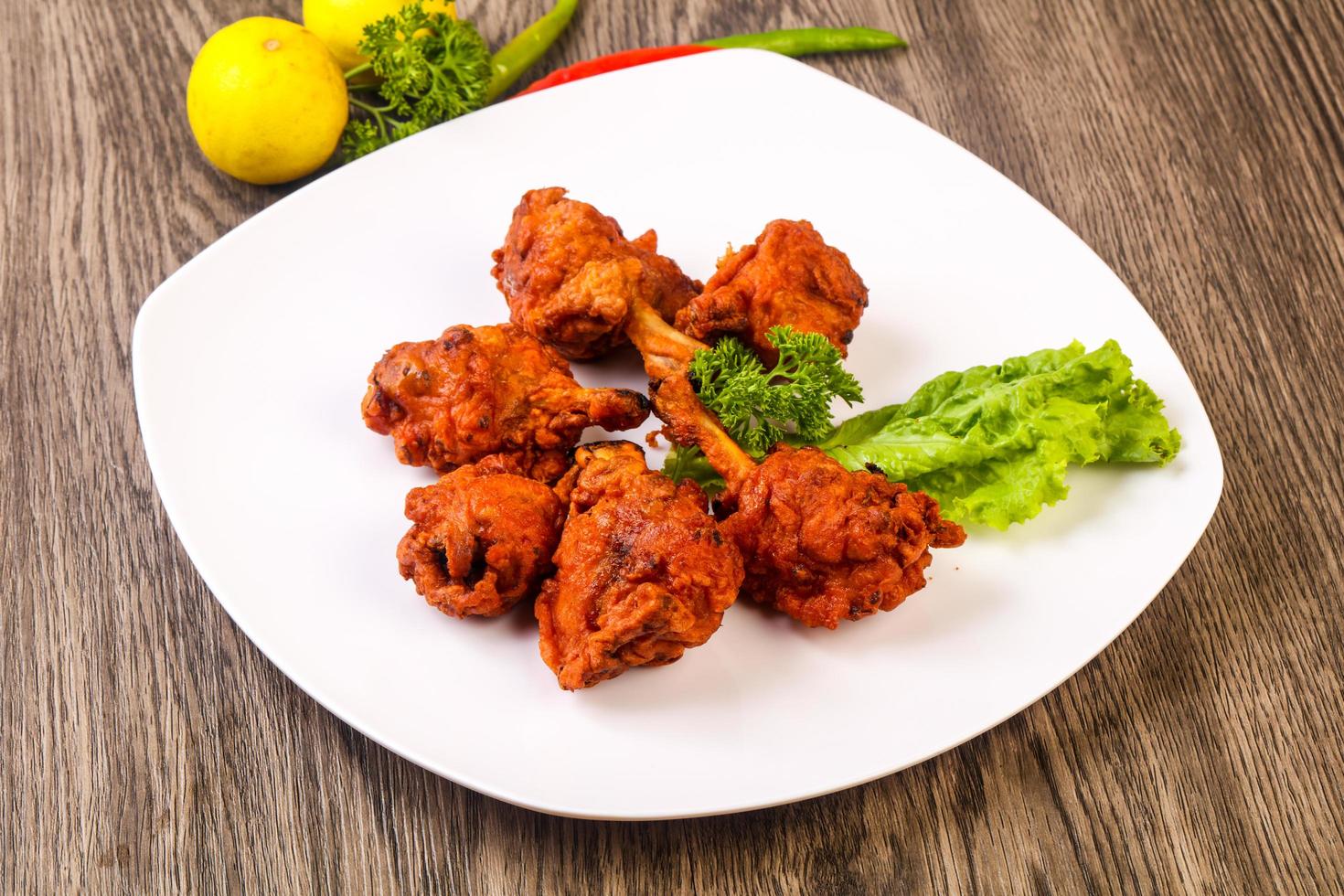 Chicken lollipops on wood photo