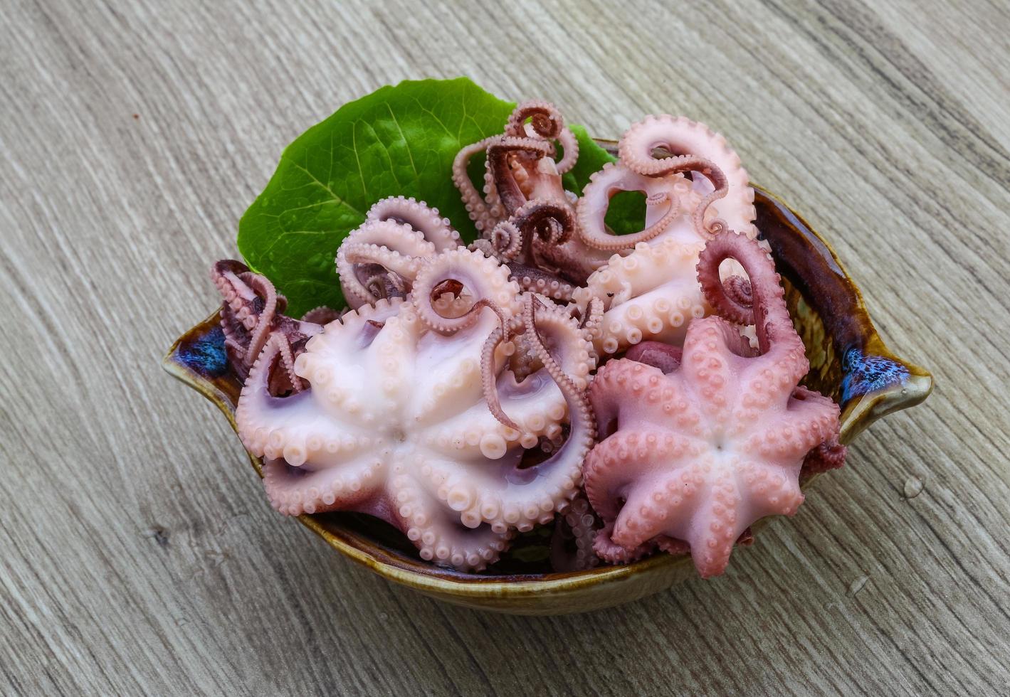 Marinated octopus on wood photo