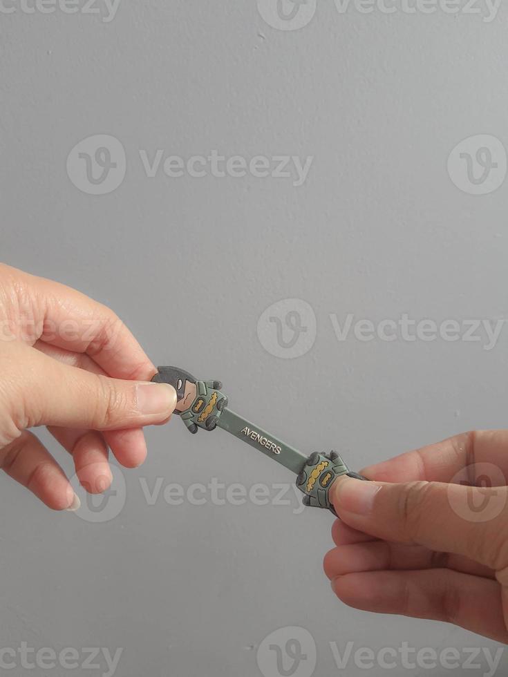 Jakarta, Indonesia in July 2021. A hand is holding a cable holder that functions to tidy up folded cables photo