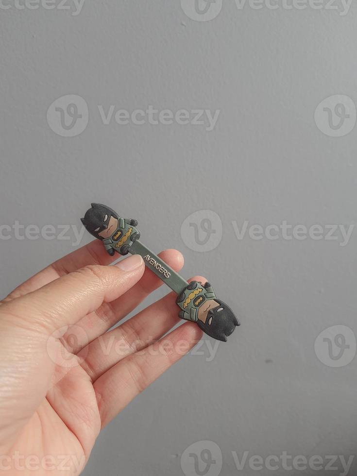 Jakarta, Indonesia in July 2021. A hand is holding a cable holder that functions to tidy up folded cables photo