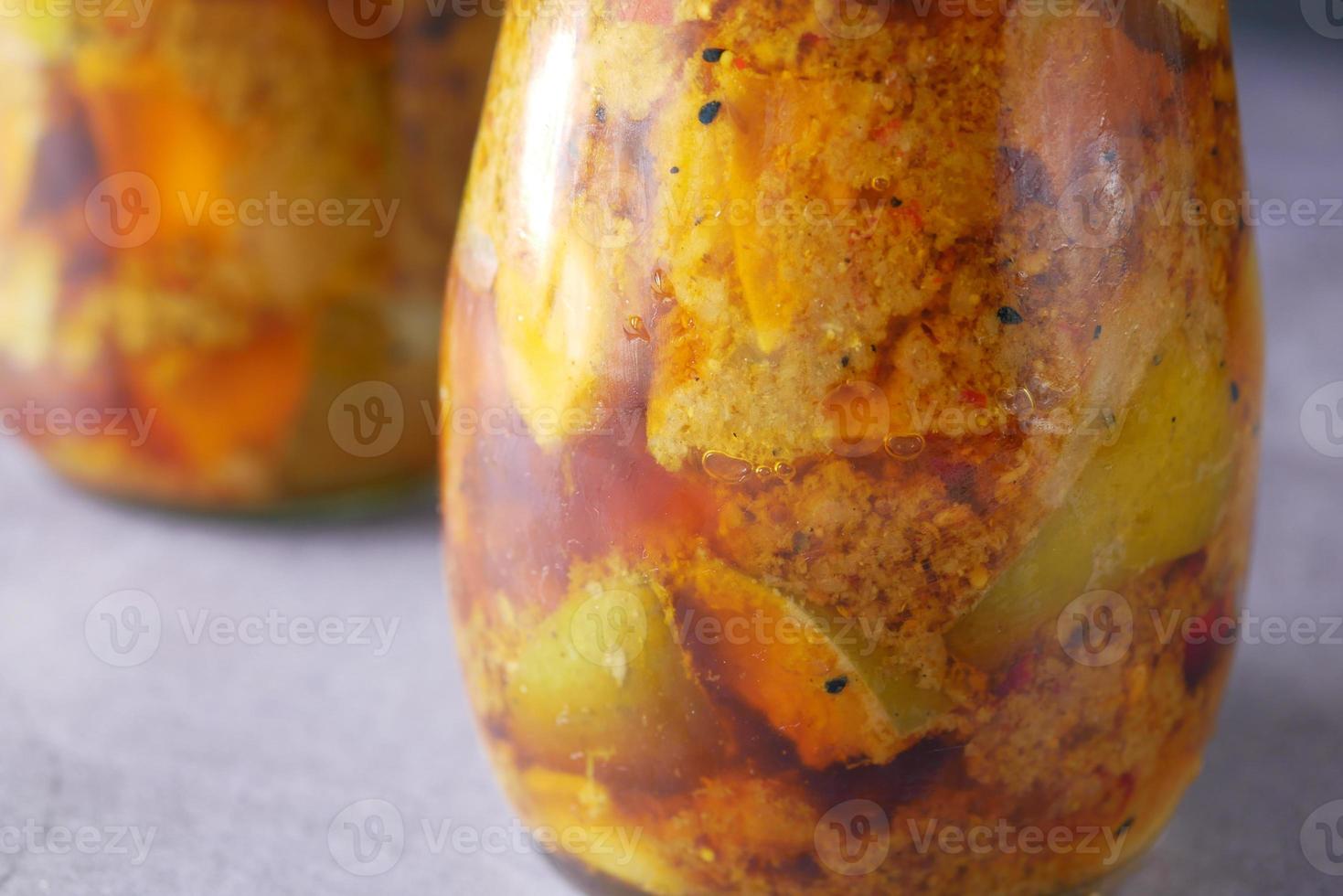 Homemade Mango Pickle in a glass jar on table , photo
