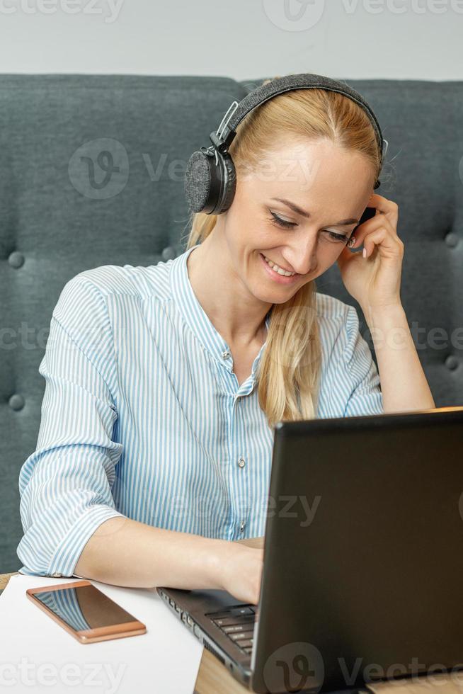 Woman is working on laptop at home office. photo