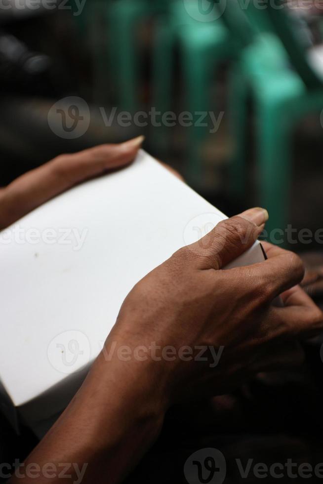 photo of hands holding a white box commonly used for rice containers at celebration parties.