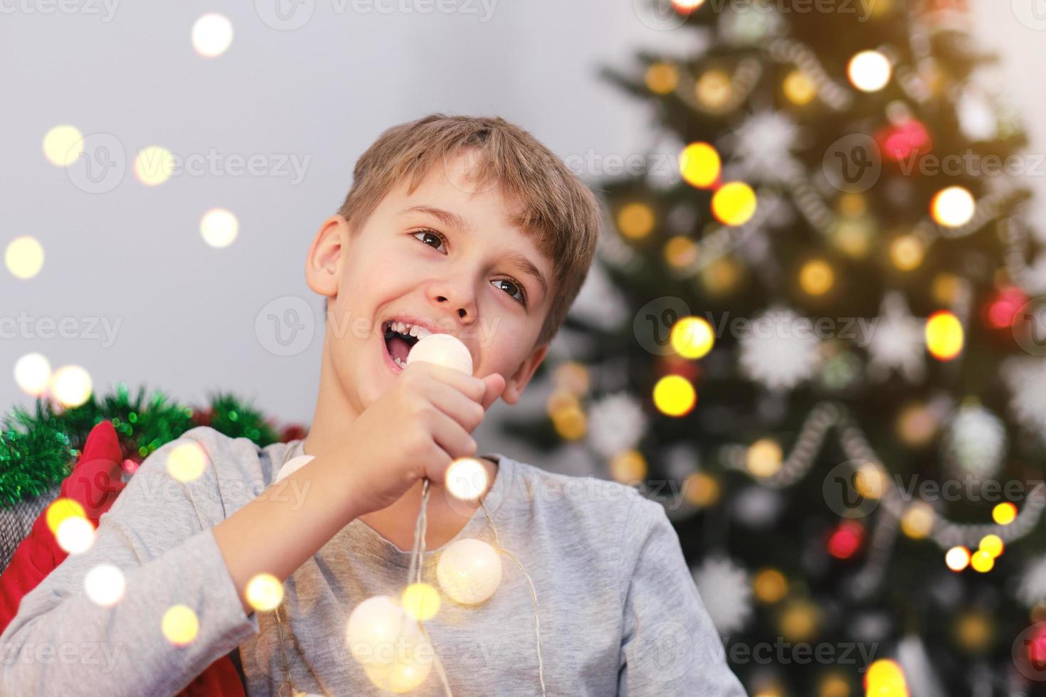 Excited Christmas boy rejoices in the Christmas holidays. photo