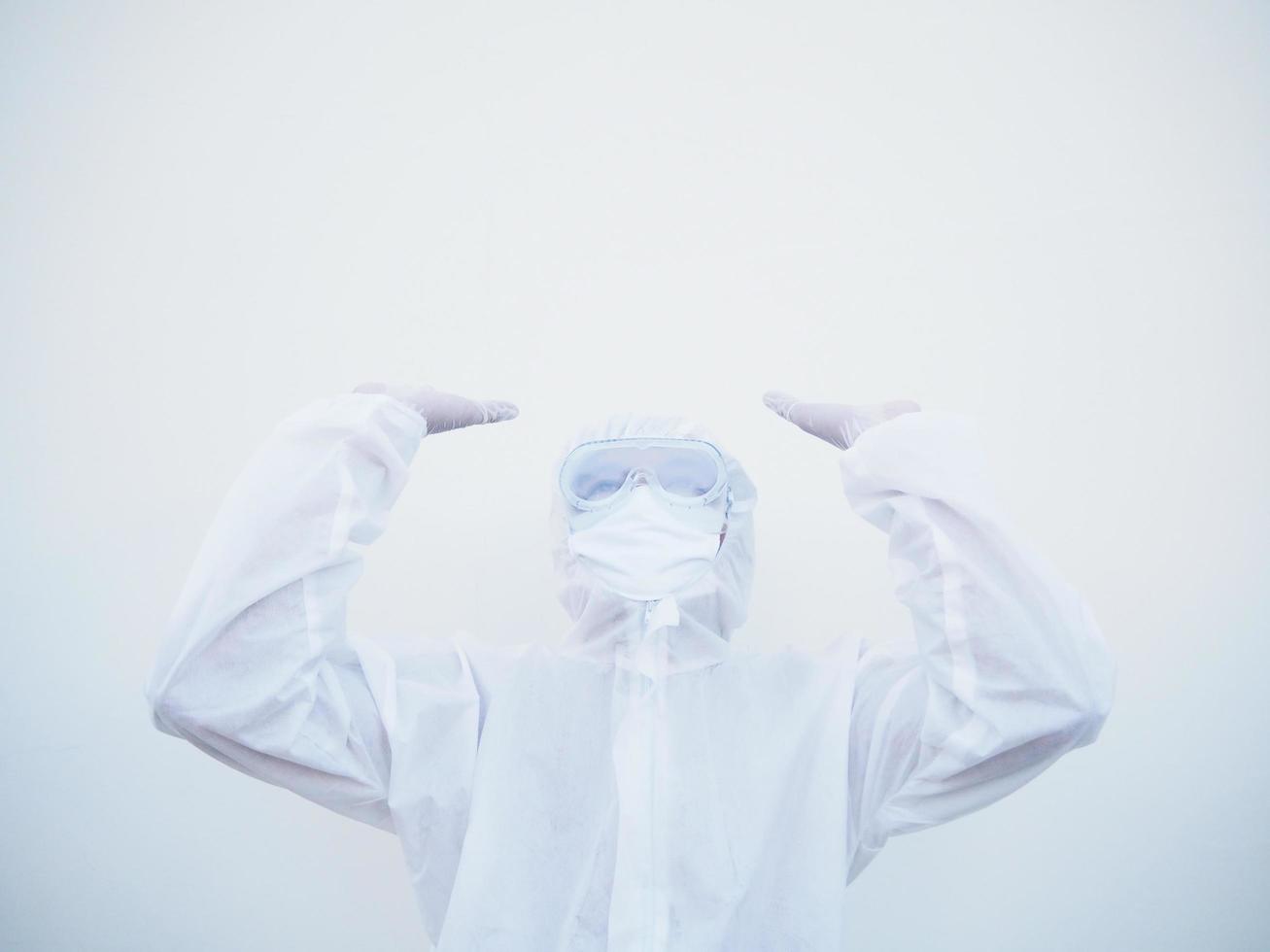 Positive young doctor or scientist in PPE suite uniform raising both hands to empty space above. coronavirus or COVID-19 concept isolated white background photo