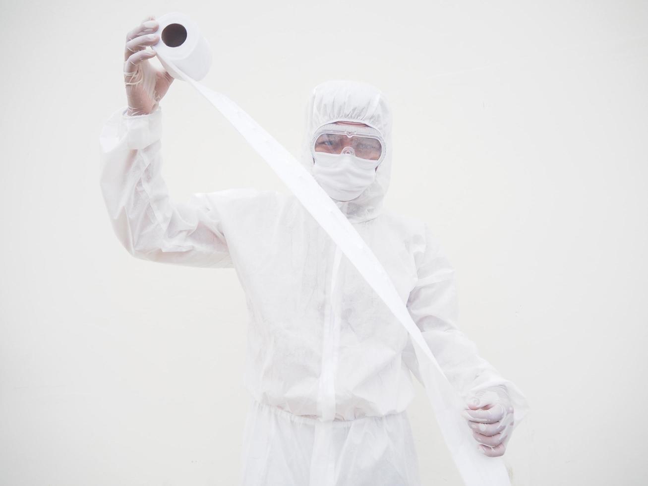 Asian male doctor or scientist in PPE suite uniform holding toilet paper. Lack of toilet paper in the quarantine of coronavirus. COVID-19 concept isolated white background photo