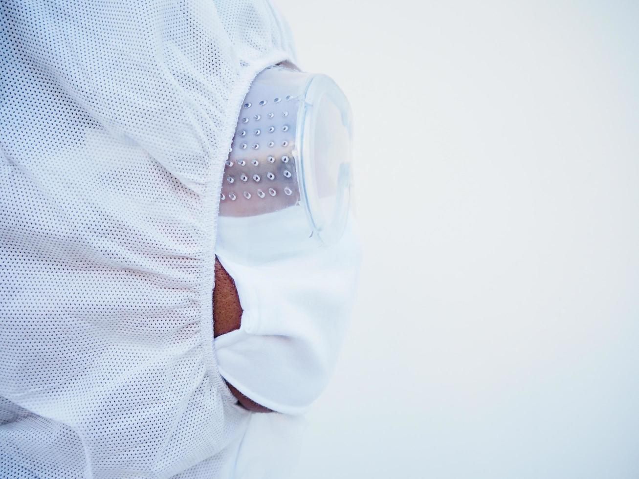 Side of face doctor or scientist in PPE suite uniform with copy space for text or design. coronavirus or COVID-19 concept isolated white background photo