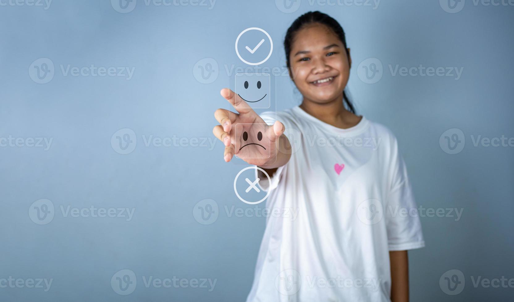 Hand choosing happy smile icon. represents feedback rating and positive customer review,. photo