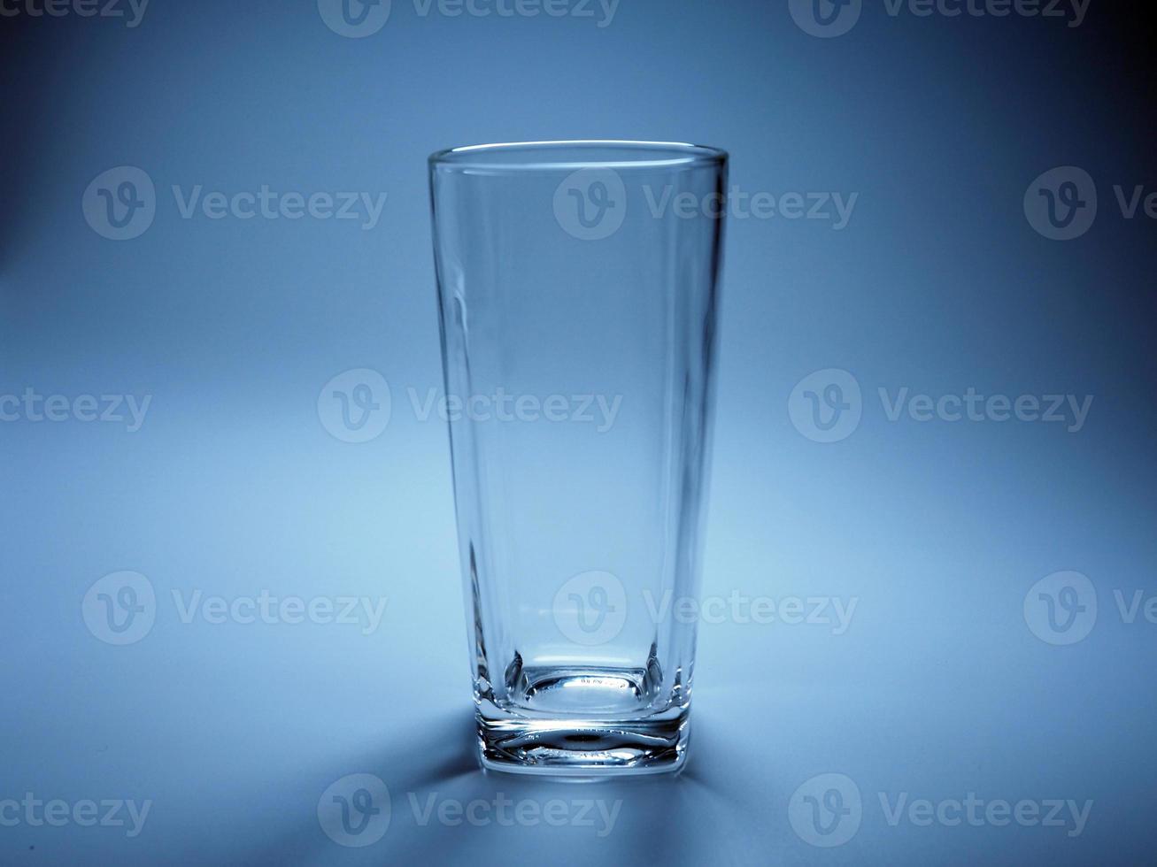 Empty glass On a blue background. photo