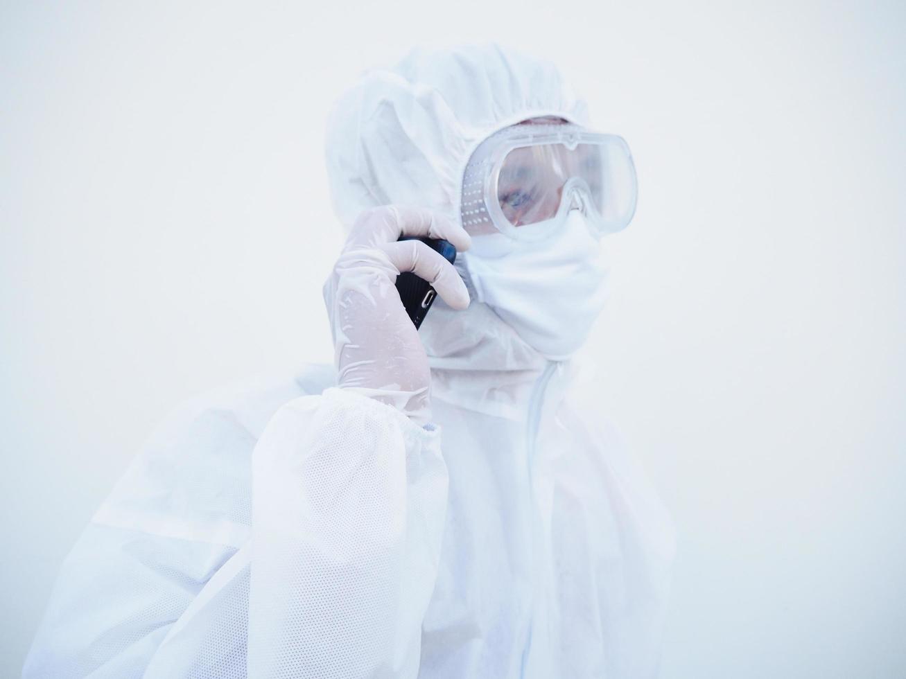 Closeup young doctor or scientist in PPE suite uniform talking on the phone with family or friend. coronavirus or COVID-19 concept isolated white background photo