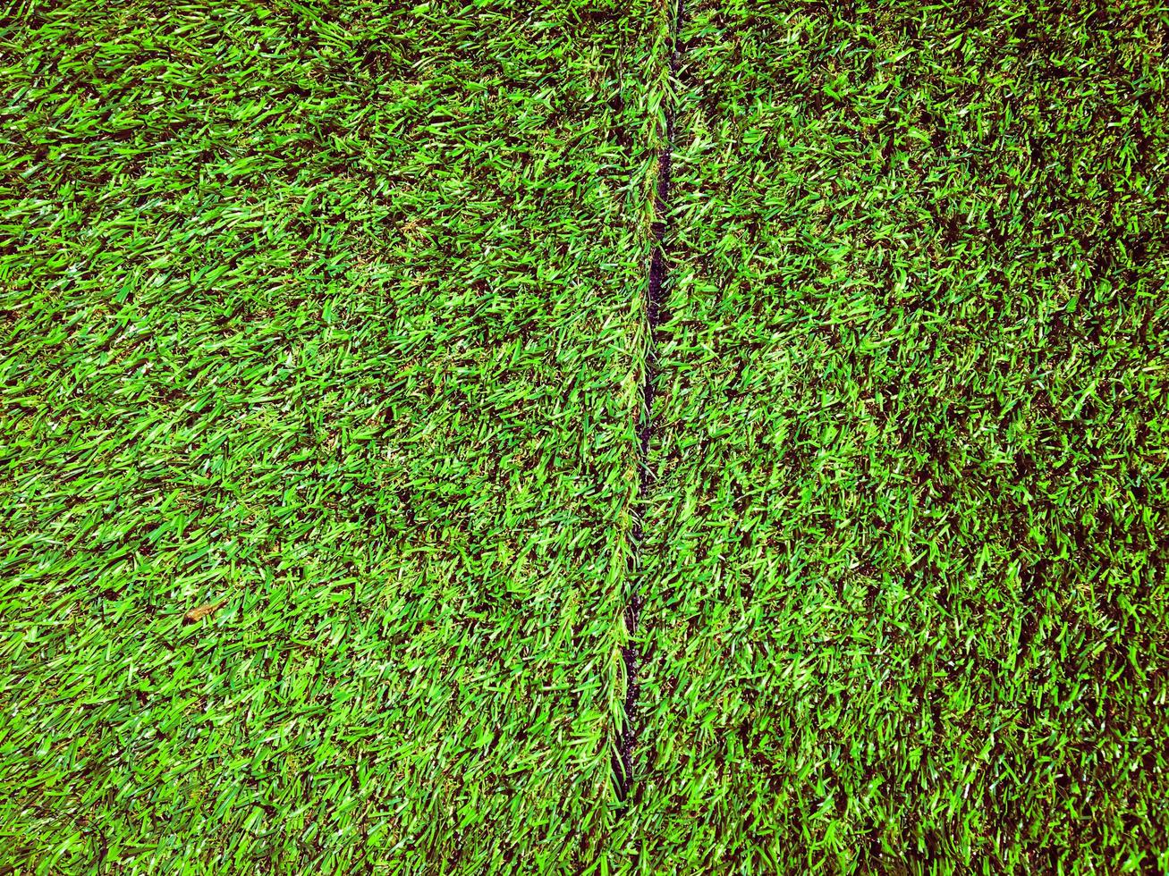 Artificial green lawn backyard for background. Texture for design photo