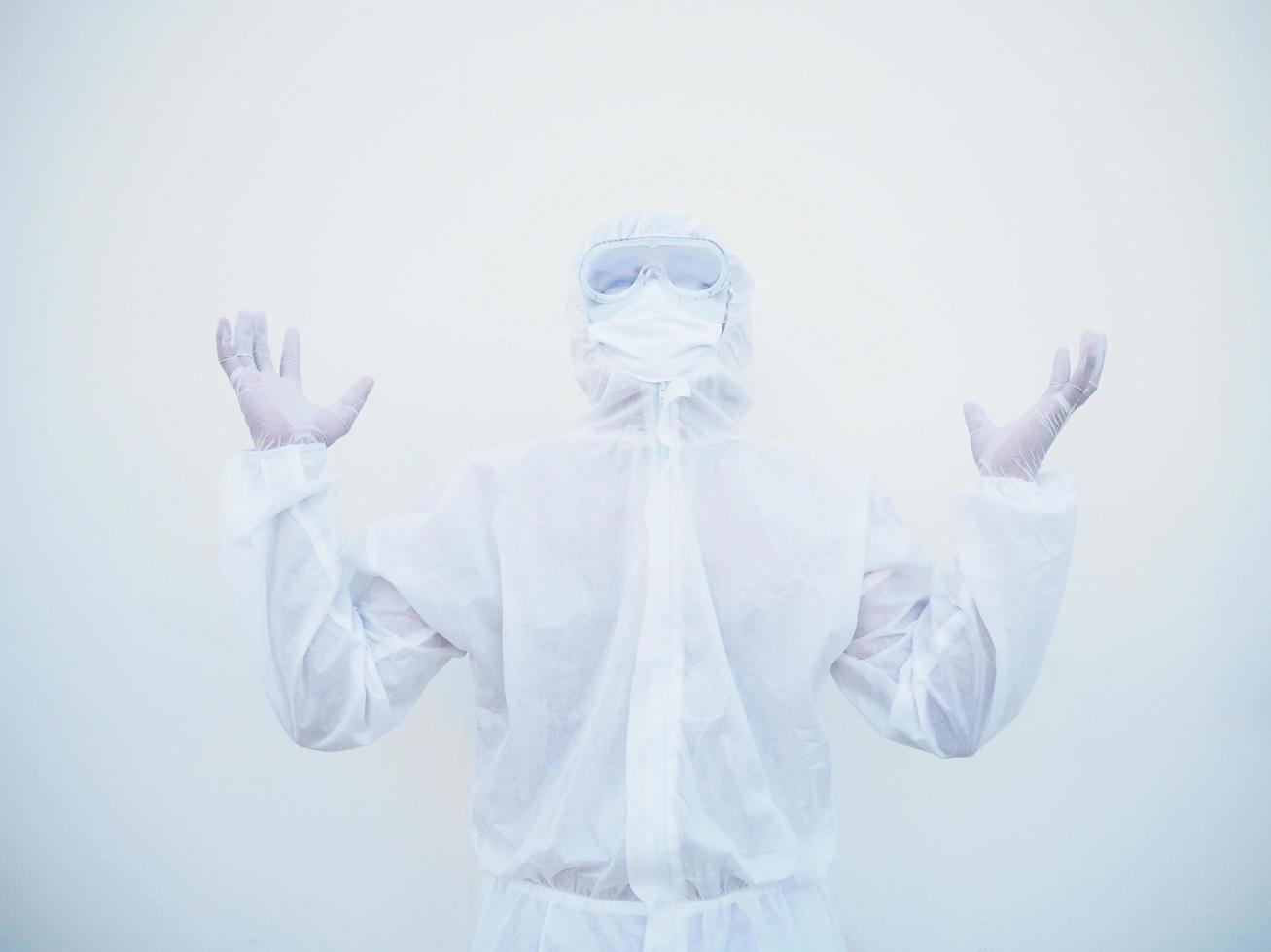 Positive young doctor or scientist in PPE suite uniform raising both hands to empty space above. coronavirus or COVID-19 concept isolated white background photo