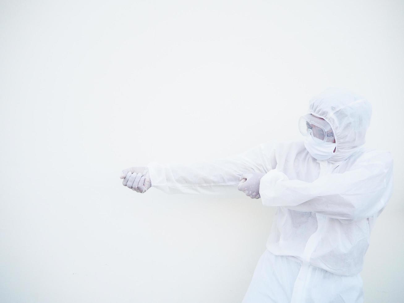 Asian doctor or scientist in PPE suite uniform showing tries to pull a strong invisible rope on a white background. coronavirus or COVID-19 concept photo