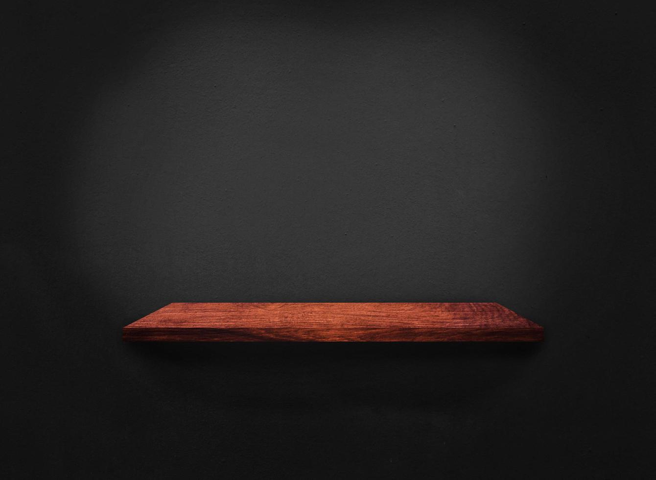 Blank of old wooden shelf on dark wall texture background with clipping path for design photo