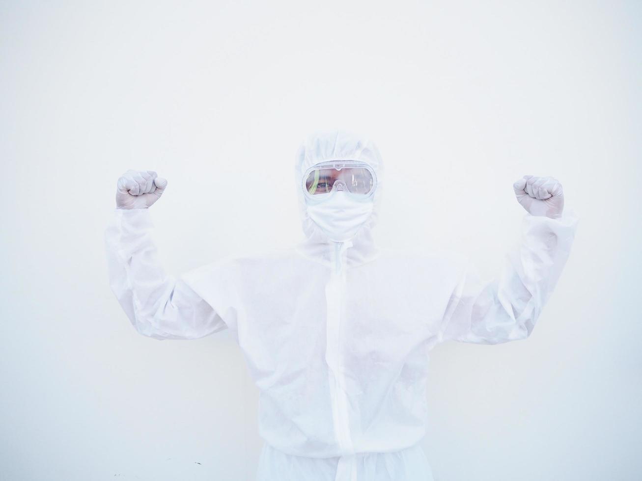 Successful emotional asian doctor or scientist in PPE suite uniform while looking ahead. clenches fists with pleasure, happiness, celebrates his victory, has great triumph.  isolated white background photo