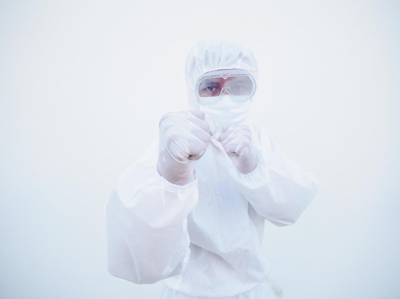 Doctor or scientist in PPE suite uniform standing with raised fists like boxer for fight with coronavirus or COVID-19 with looking forward isolated white background photo