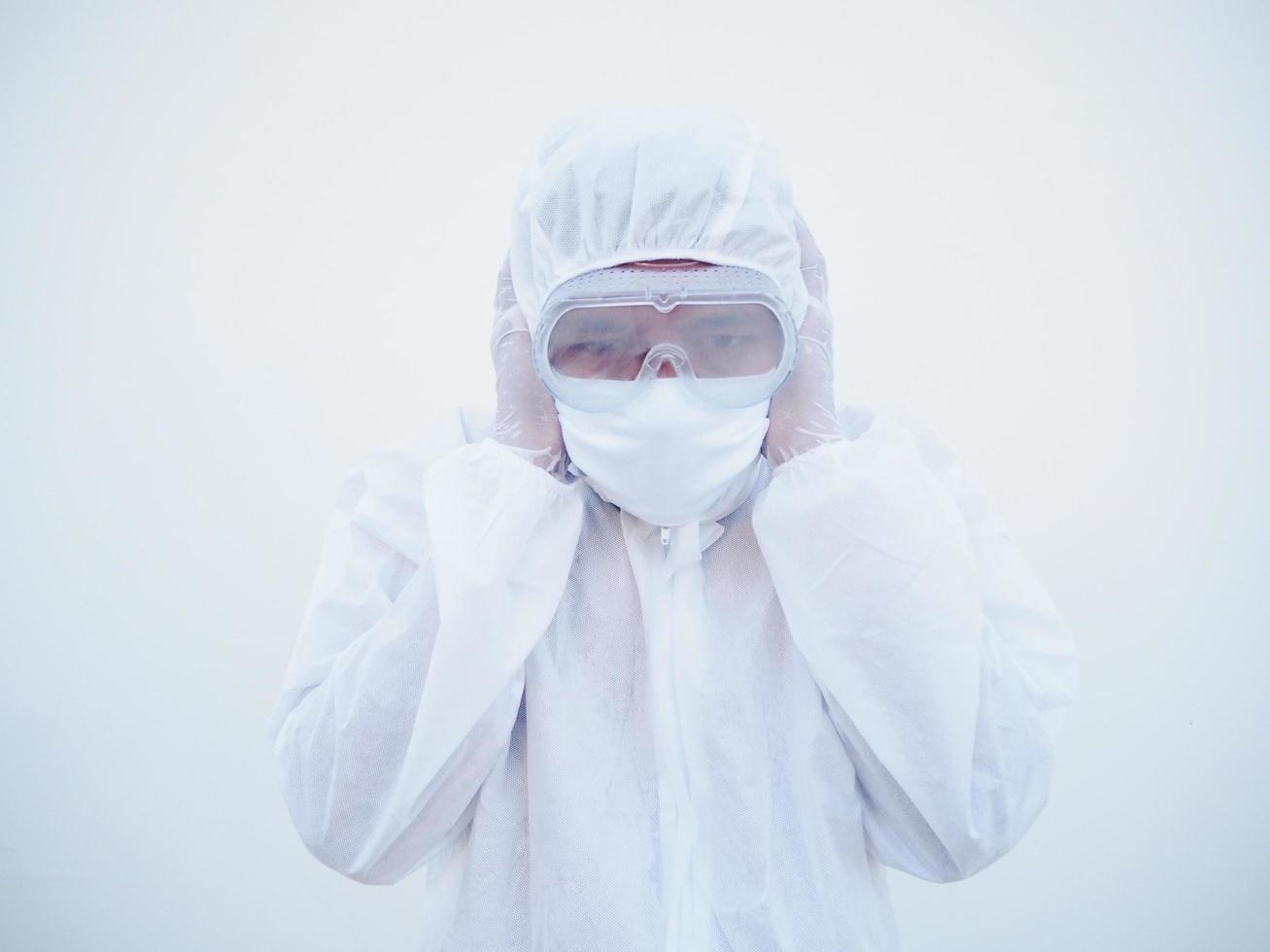 Asian doctor or scientist in PPE suite uniform covers ears with hands. Danger of coronavirus or COVID-19 concept isolated white background photo