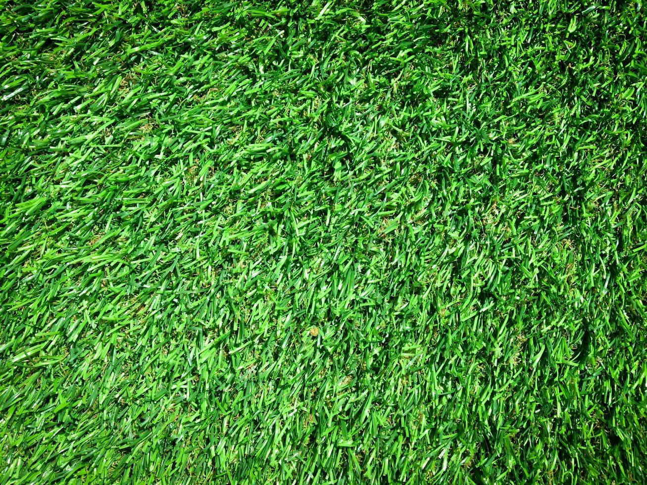 Artificial green lawn backyard for background. Texture for design photo