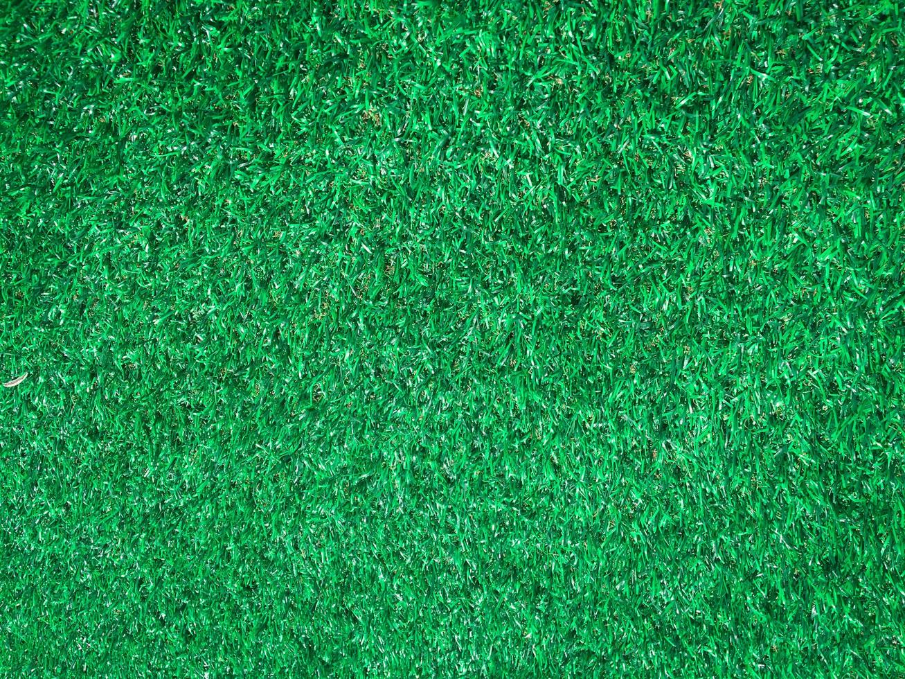 Closeup view of green grass soccer field background. Wallpaper for work and design. photo