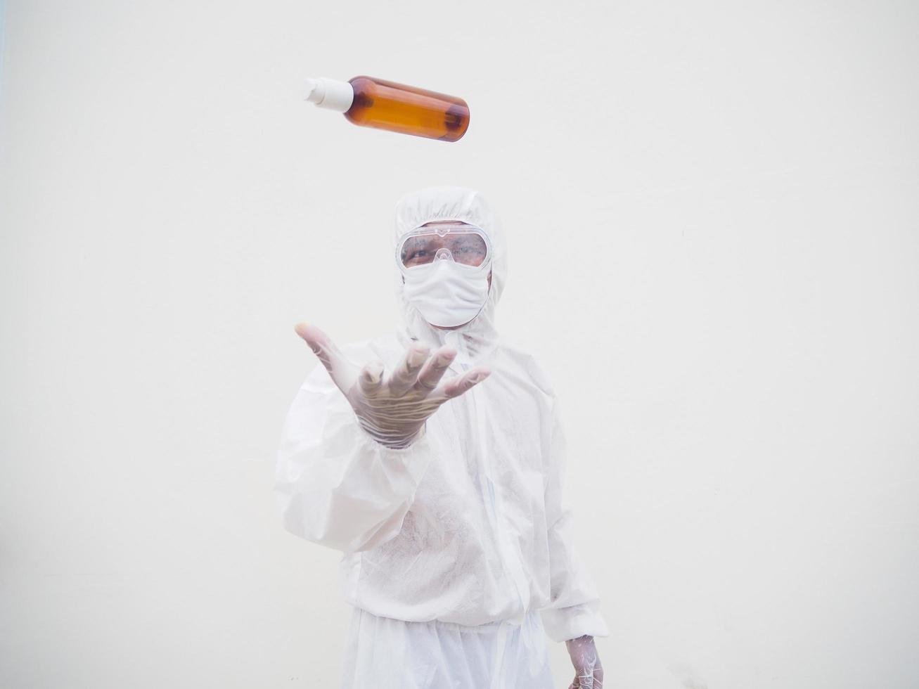 Portrait of doctor or scientist in PPE suite uniform holding plastic bottle with skin care product. COVID-19 concept isolated white background photo