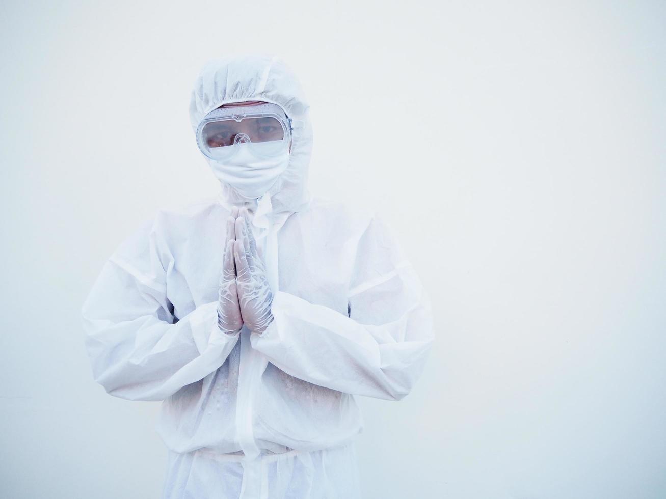 Closeup of asian male doctor or scientist in PPE suite uniform has stress and pray during an outbreak of coronavirus or COVID-19 isolated white background. photo