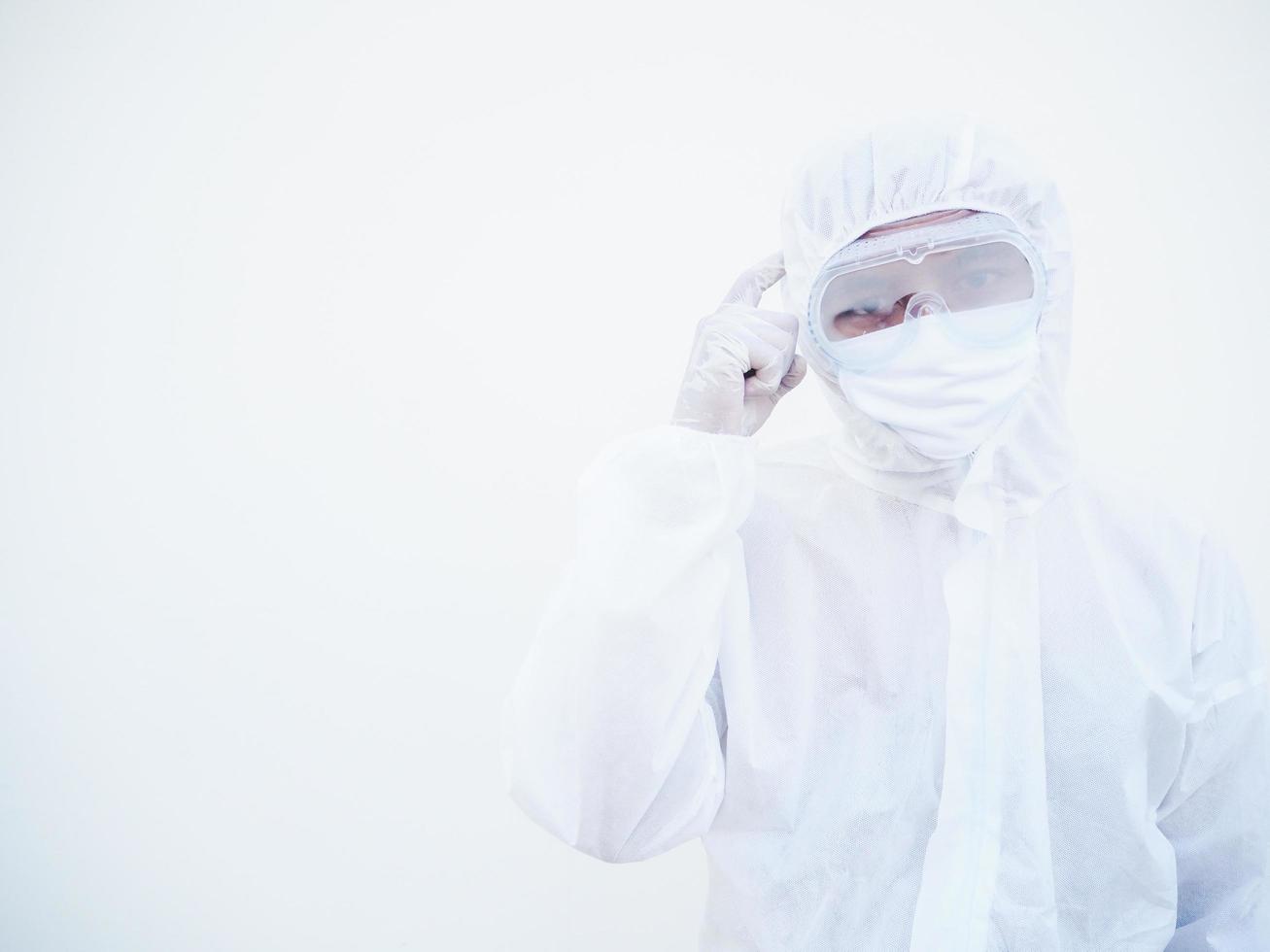 Asian male doctor or scientist in PPE suite uniform showing pointing fingers at to brain while standing and looking forward with copy space for text or design. coronavirus  isolated white background photo