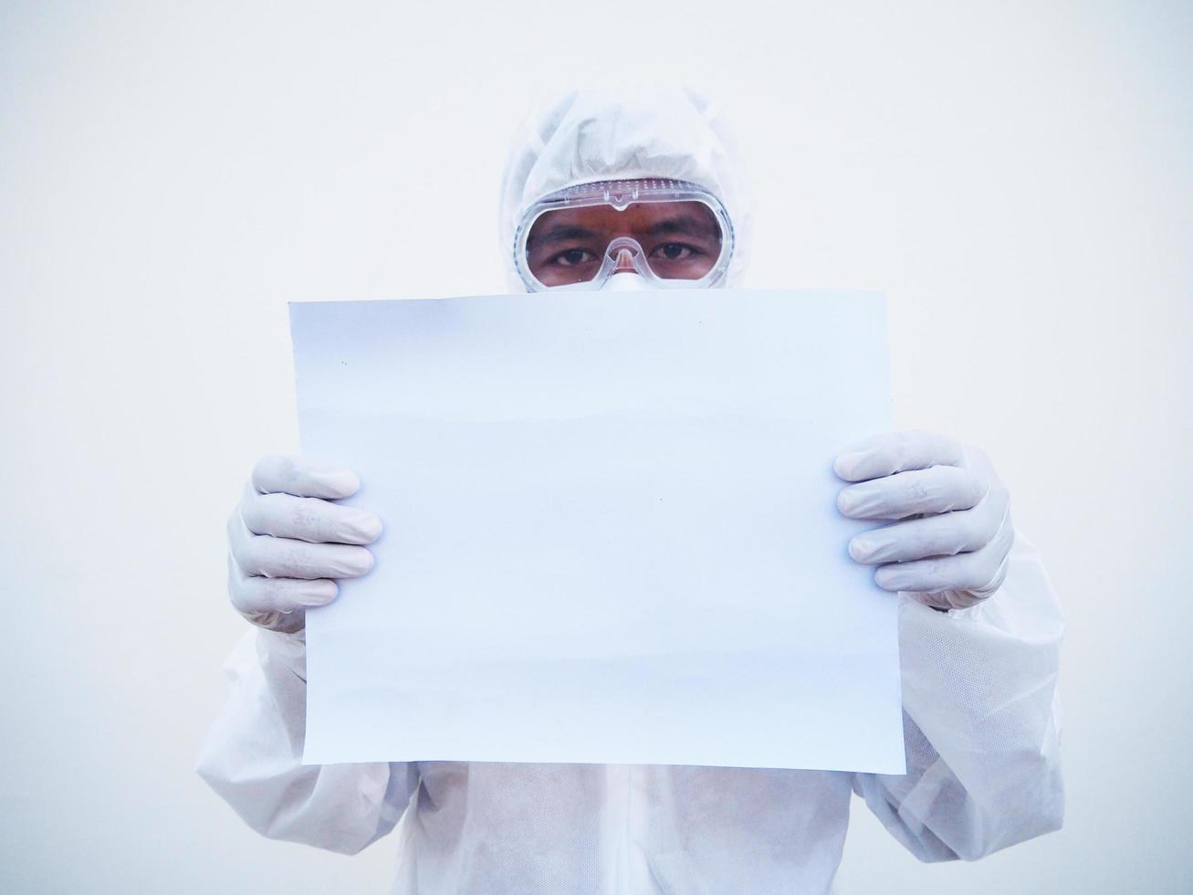Young doctor or scientist in PPE suite uniform holding blank paper for text with both hands While looking ahead. coronavirus or COVID-19 concept isolated white background photo