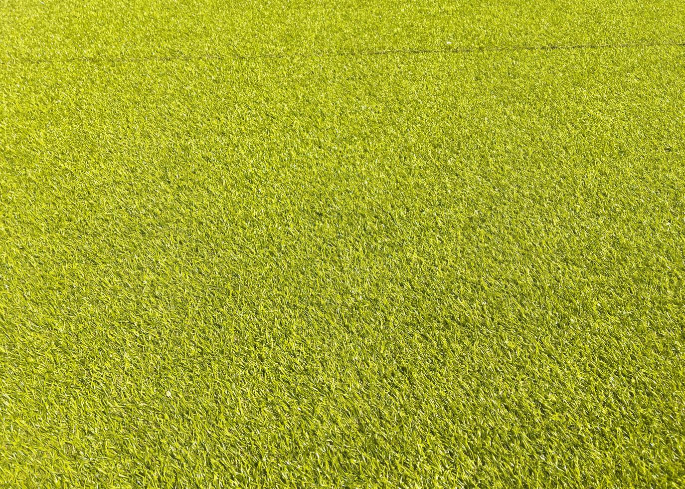 Artificial green lawn backyard for background. Texture for design photo