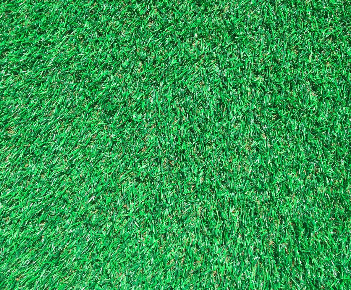Artificial green lawn backyard for background. Texture for design photo
