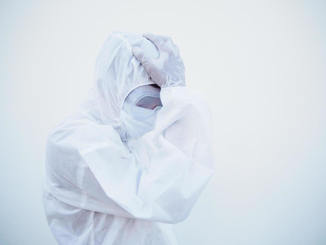 Asian male doctor or scientist in PPE suite uniform In a manner that puts his hand on his head with feeling strees and headache. coronavirus or COVID-19 concept isolated white background photo