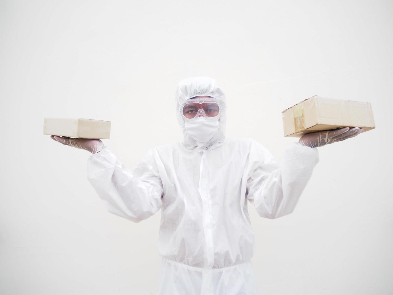 Young man in PPE suite uniform while holding cardboard boxes in medical rubber gloves and mask. coronavirus or COVID-19 concept isolated white background photo