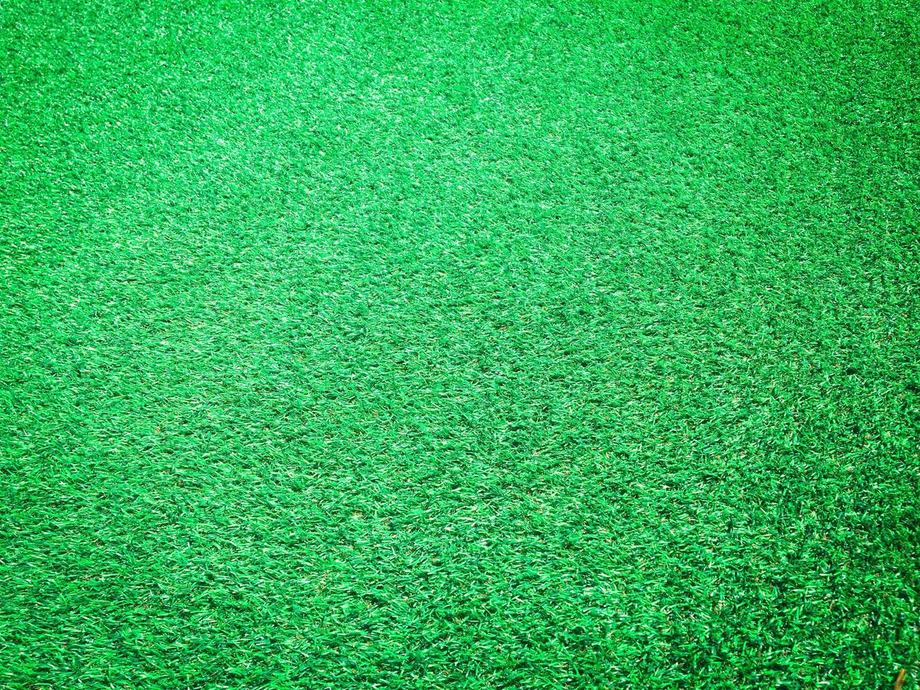 Artificial green lawn backyard for background. Texture for design photo