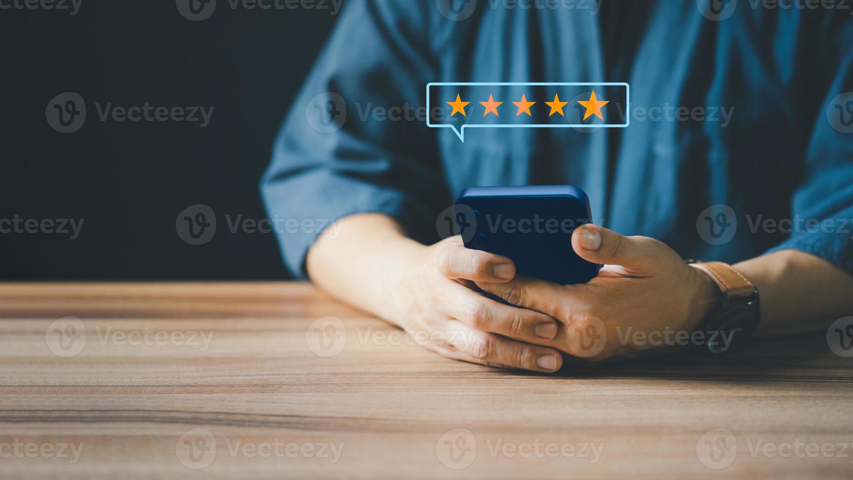 Man using a smartphone in give rating to service experience on application. Online customer review satisfaction feedback survey. photo