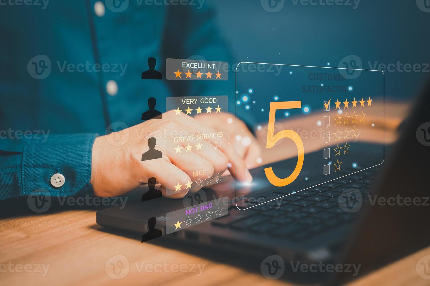 Man hand using computer laptop with popup five star icon for feedback review satisfaction service, Customer service experience and business satisfaction survey. photo