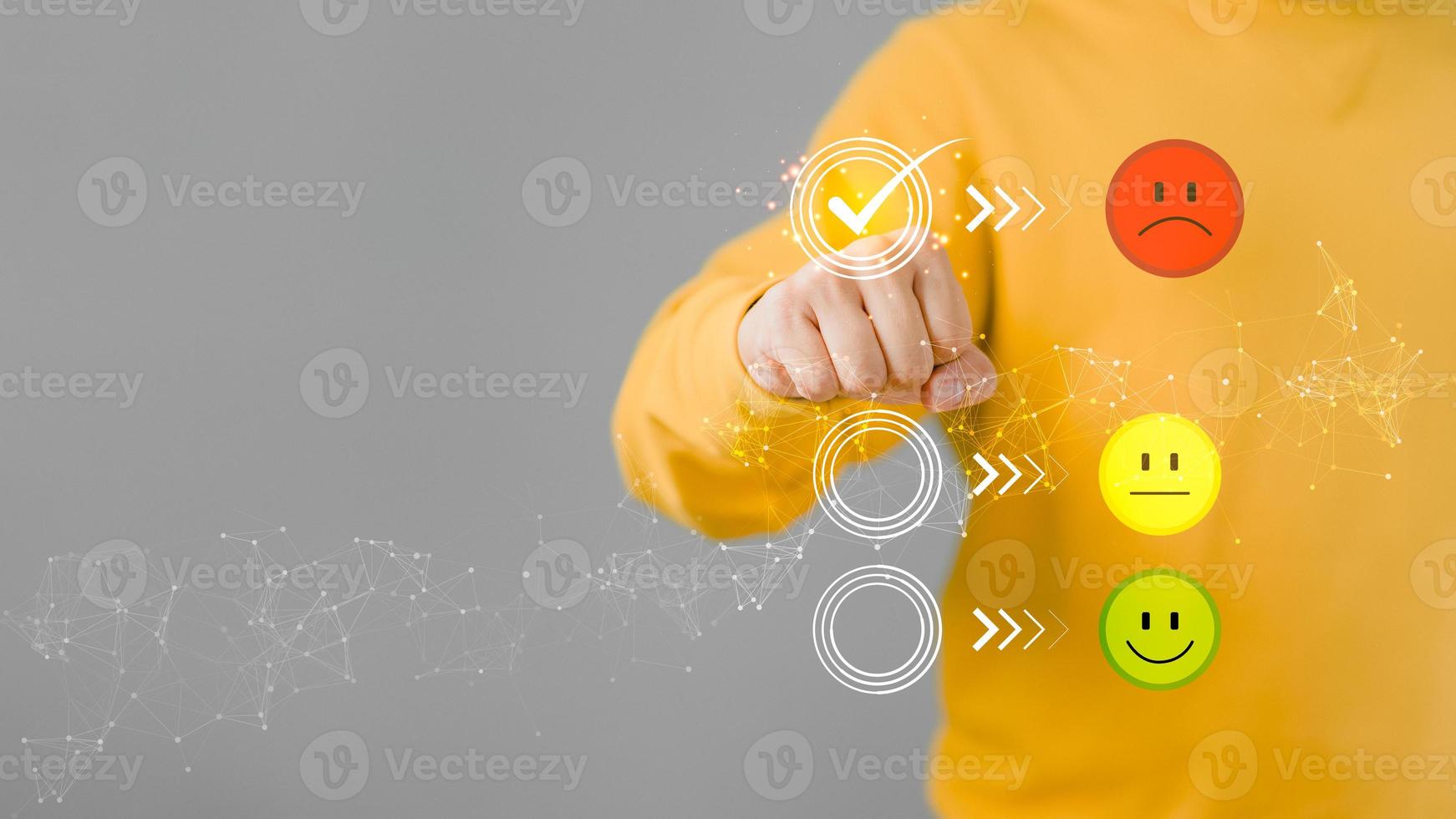 Man touching the virtual screen on the unhappy angry face icon in give rating to service experience on application. Online customer review satisfaction feedback survey. photo