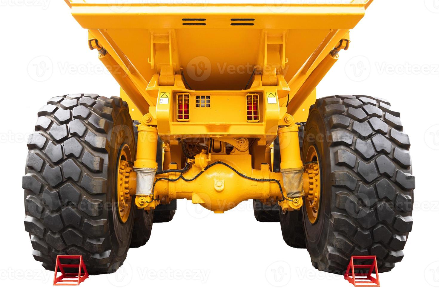 Mining, mining dump truck of yellow color on a white isolated background. Back view. photo