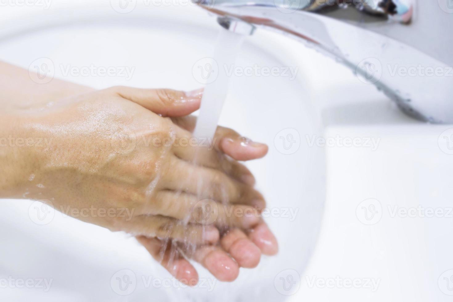Hygiene. Cleaning Hands. Washing hands with soap under the faucet with water Pay dirt. photo