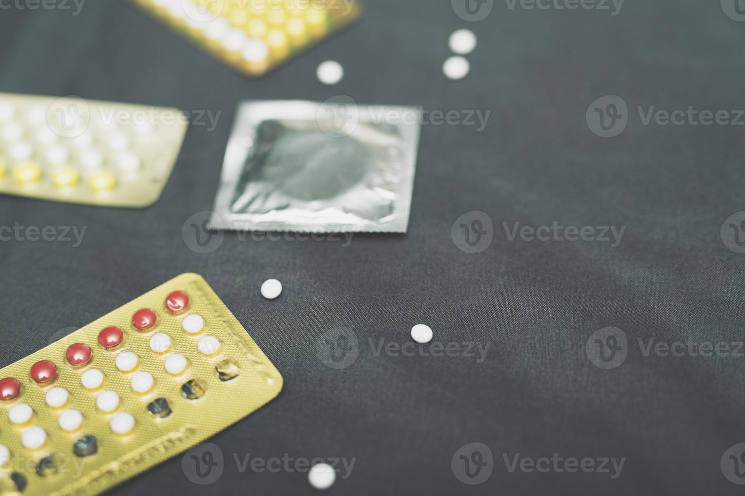 Contraceptive means contraceptive pills and condom on the bed. Protection, safe sex. Contraception, concept birth control. Copy space, top view with copy space. photo