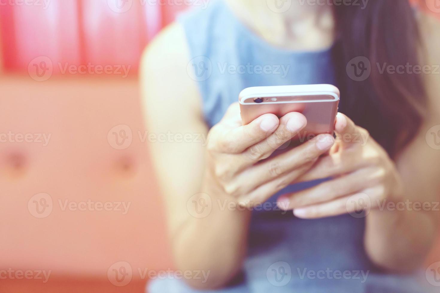 female hand holding pointing finger on screen mobile smartphone touching screen and using app. information content,  reading text message on cell telephone during in urban. photo