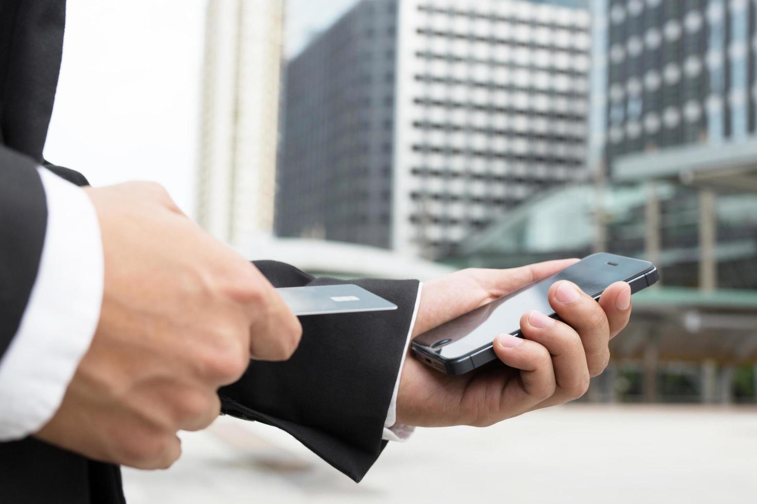 businessman hands holding credit card and using phone. Online shopping purchase Sell or Payment. photo