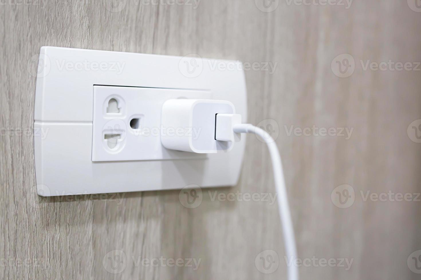 Close Up the electrical power socket and plug socket on wall. photo