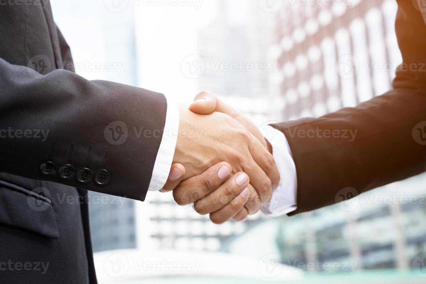 Closeup of a businessman hand shake investor between two colleagues  OK, succeed in business Holding hands. photo