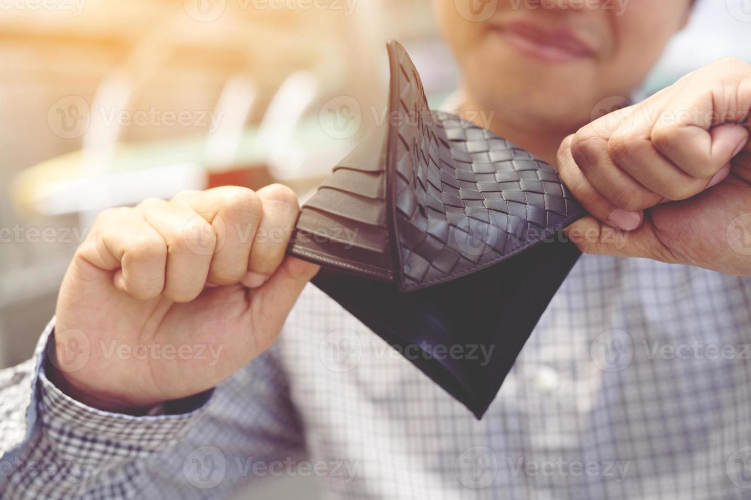 Empty wallet no money in the hands of an businessman. High cost of living in city Cost control expenses poverty in concept. photo