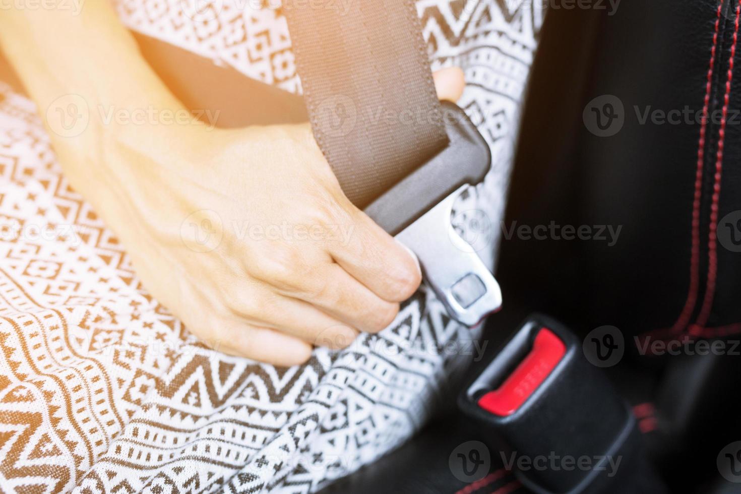 Close Up of people fastening seat safety belt in car for safety before driving on the road. concept transport travel. photo