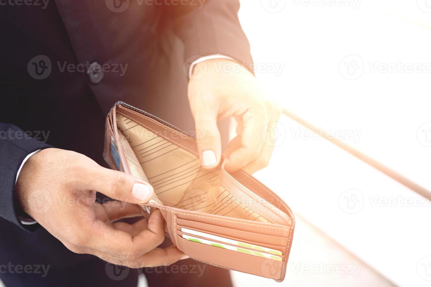 Empty wallet no money in the hands of an man. Cost control expenses poverty in concept. Leave space to write descriptive text. photo