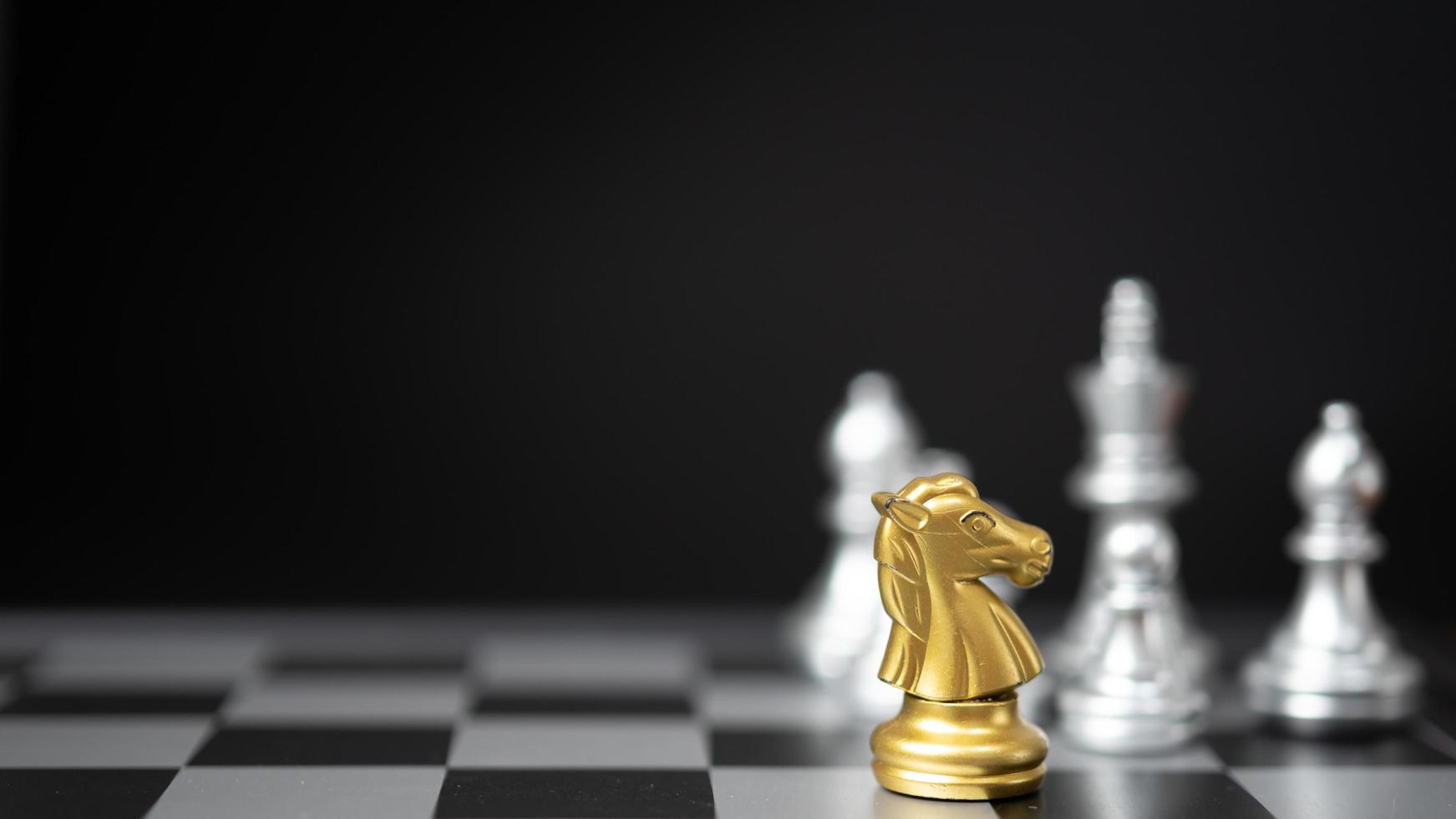 Strategy and business planning ideas. Chess horse gold on the board. photo
